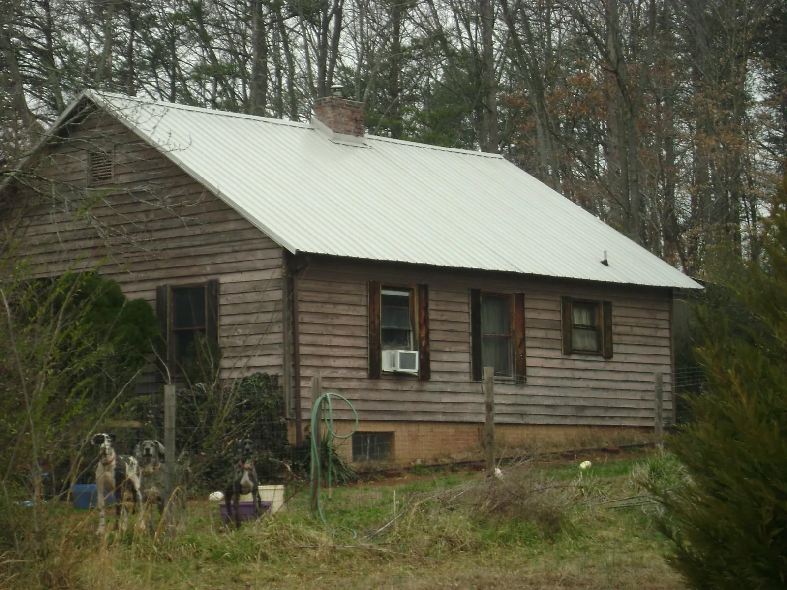 White metal roof on an old wood sided farmhouse, from a Metal Roof Installation job in Lima